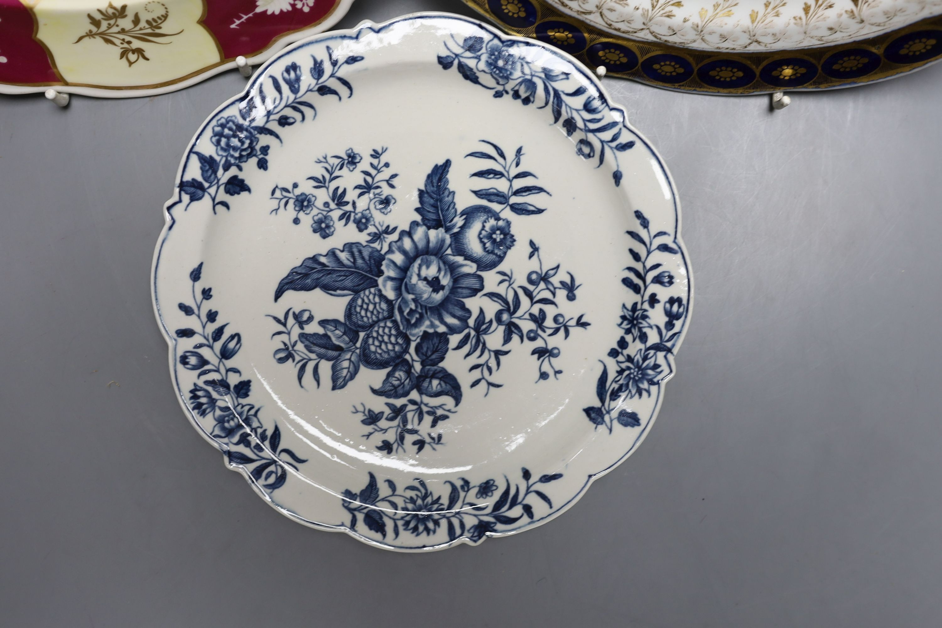 A Chamberlains Worcester armorial plate, a Worcester pinecone pattern plate, c.1775 and a Chamberlains Worcester chinoiserie plate (3) largest 27cm diameter